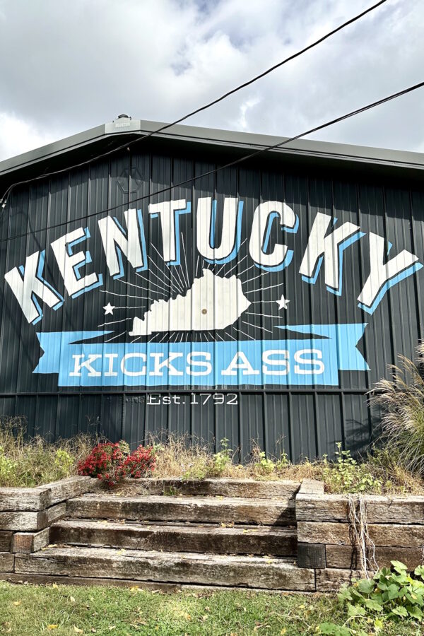 weekend trip to kentucky. mural painting that says kentucky kicks ass